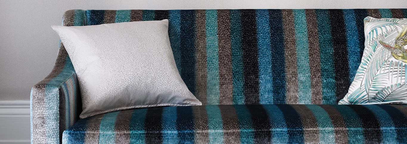 A sofa covered in striped velvet